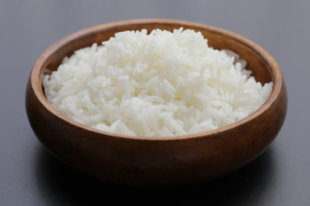 istock Cooked rice in bowl on dark background. 1916364374