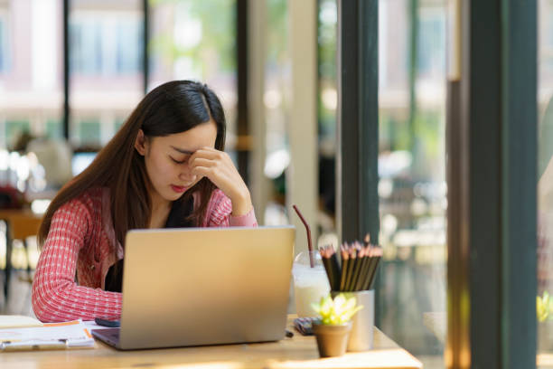 istock Asian businesswoman working on a laptop computer, stressed has a headache, and thinks hard from work at the office. 1916372497
