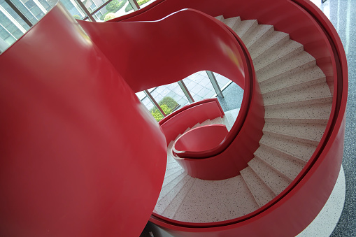 Spiral red handrail staircase