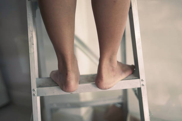 Close-up standing leg on the folding ladder