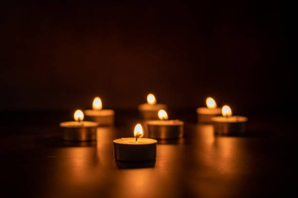 istock Many candles lit against a black background.Burning candles on dark tableMemory day 1916450634