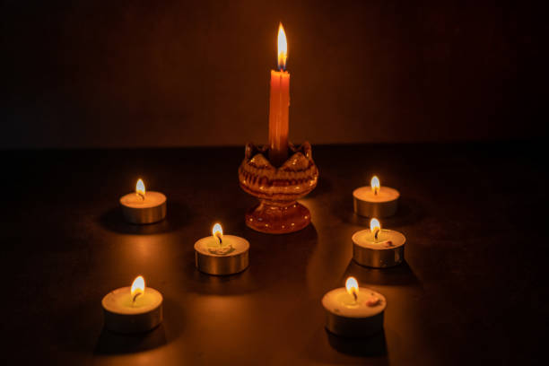 istock Many candles lit against a black background.Burning candles on dark tableMemory day 1916450639