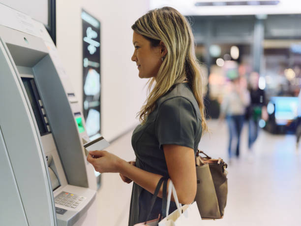 istock Young female entrepreneur withdrawing money from ATM. 1916451699