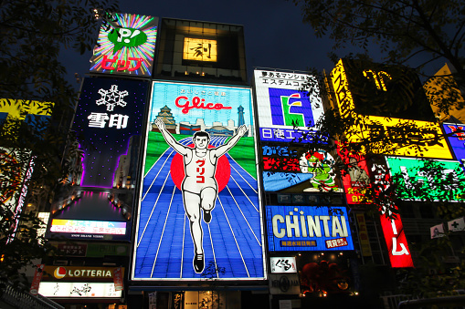 Osaka, Japan - April 18, 2010: The Glico Running Man and Neon Signs over the Dotonbori canal