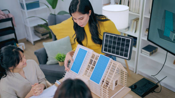 istock Architects team are working on paper blueprint and building model. 1916478718
