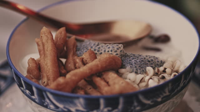Tofu pudding in ginger syrup with deep-fried dough stick