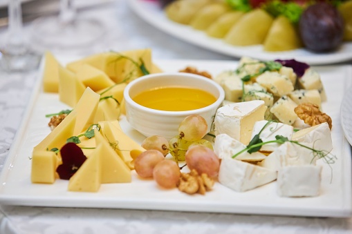 Cheese plate, assorted cheeses. Dishes from the chef in the restaurant. Festive table