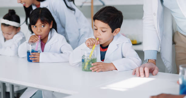 istock Study, science and kids in class for an experiment while learning chemistry together at school. Education, laboratory and innovation with student children in a classroom for growth or development 1916539713