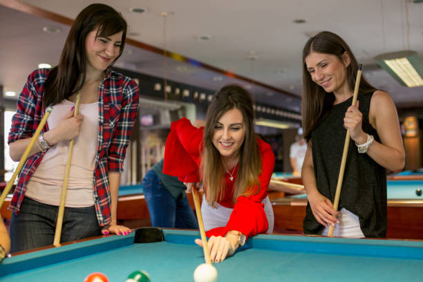 istock Group of friends play billiards 1916551019