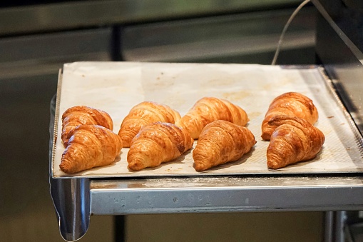 A tray of croissants, freshly out from the oven.