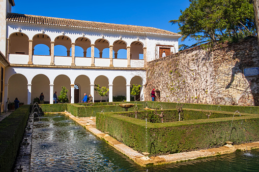 Tourists visiting the Patio de la Sultana, part of the Generalife in the Alhambra of Granada, the main landmark of the city and one of the most famous monuments of Islamic architecture in the world