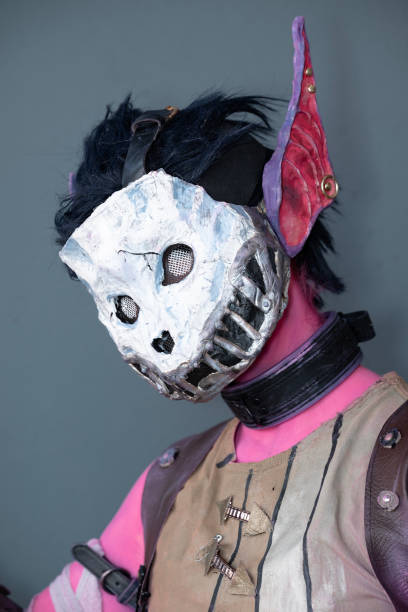 istock Female cosplayer dressed as a pink monster with a skull mask 1916591421