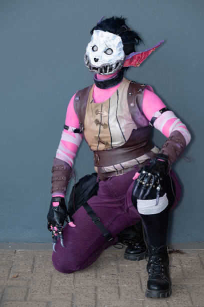 istock Female cosplayer dressed as a pink monster with a skull mask 1916591422