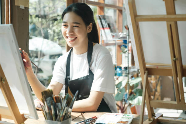istock Crafting Inspiration: Female Artist Sketching and Painting in Workshop 1916592073