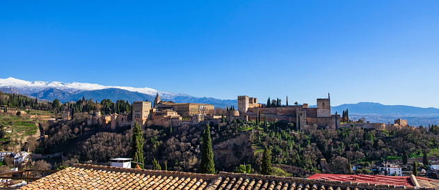 Old town of Granada seen from an arched window in the Alhambra