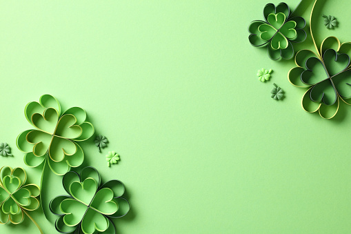 Four leaf clover paper cut on green background. St Patricks Day banner design