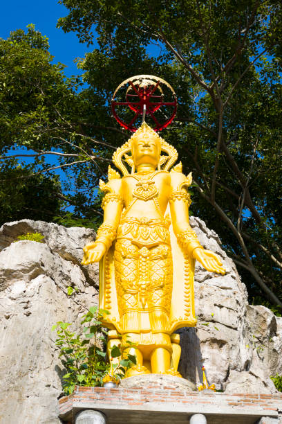 Slim thai golden buddha statue Slim thai golden buddha statue on top of big rock at end of steps leading up in small village Paranghmee near Noen Maprang in Phitsanulok province. true thailand classic stock pictures, royalty-free photos & images