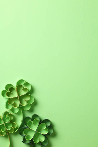 istock St patricks day background with clover paper cut art on green background. 1916606465