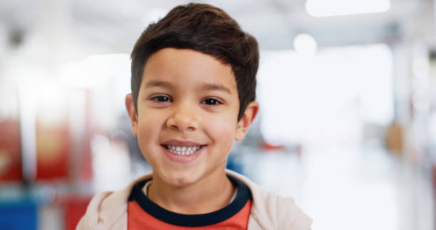 istock Portrait, boy and child with learning for knowledge, scholarship and education with smile at school. Face, student and kid with confidence or happy at academy or classroom for childhood development 1916612370