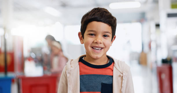 istock Young, student and classroom with happy portrait for education, kindergarten or kid learning in casual style. Boy, child and face at academy to study, develop and excited at school with scholarship 1916612374