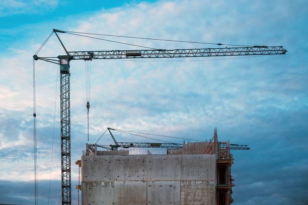 istock Tall prefabricated residential building construction site with old crane 1916623951