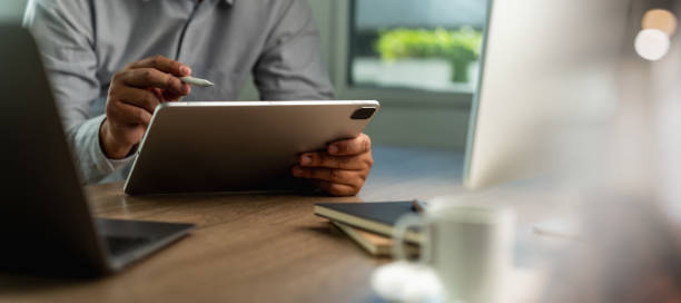 istock businessman work use reading and hand holding digital tablet technology screen connecting wifi read information in application 1916628287