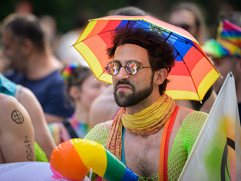 Vienna, Austria - June 17, 2023: People at Vienna Pride in summer on Wiener Ringstrasse, bearded man with sunglasses and a colorful hat