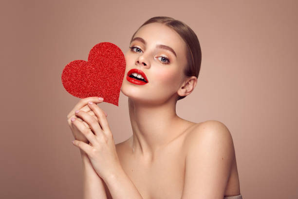istock Beautiful woman holding an artificial red heart 1916641743
