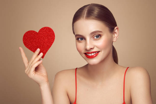 istock Beautiful woman holding an artificial red heart 1916642788
