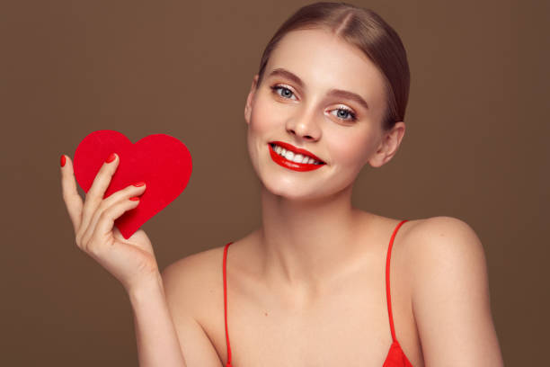 istock Beautiful woman holding an artificial red heart 1916642797