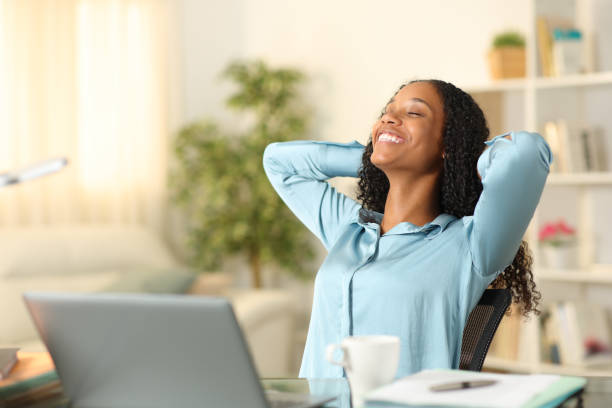 Happy tele worker relaxing breathing at home Happy tele worker relaxing breathing at home relief emotion stock pictures, royalty-free photos & images