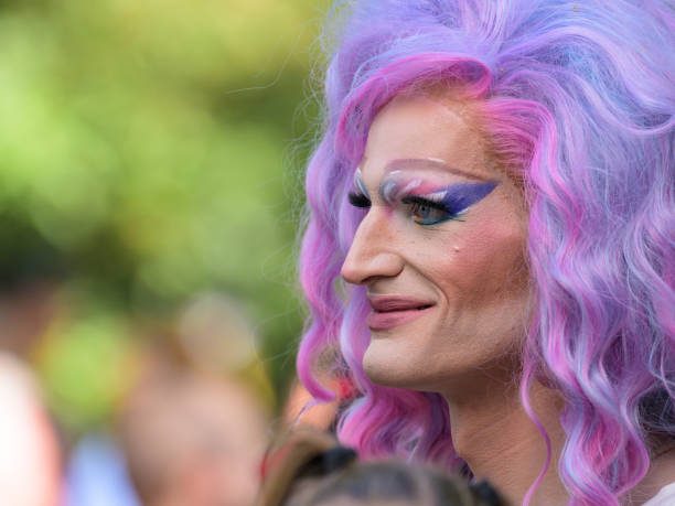 Child wearing colorful wig having fun at street carnival