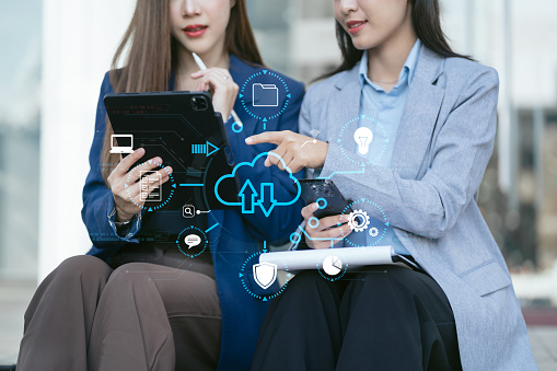 Woman is using a smartphone and tablet to access the cloud computing system , Storage and data transfer Cloud network , Cloud technology, Networking Secure Access Service Edge  and internet service concept.