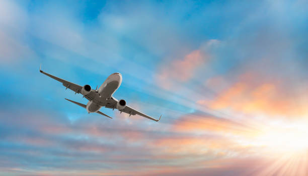 istock Airplane flying over stormy tropical sea at sunset 1916664491