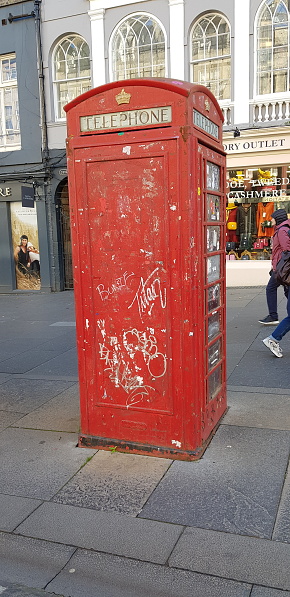 Red old telephone booth, telephone box at a street, the Royal Mile, Edinburgh Scotland England