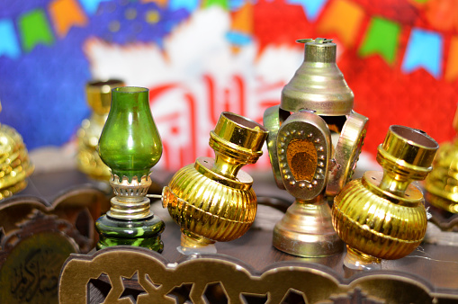 Translation of Arabic text (Ramadan Kareem or Happy generous Ramadan), Ramadan decorative fava beans cart with beans jar container and Fanous lamp lantern decorations for the fasting month for Muslims, selective focus