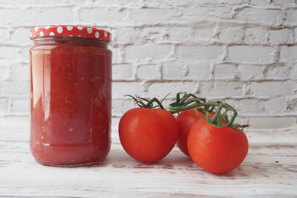 istock Tomato juice in jars is located on a table 1916688432