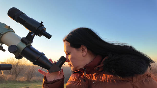 istock Amateur astronomer observing skies with a telescope. 1916695143