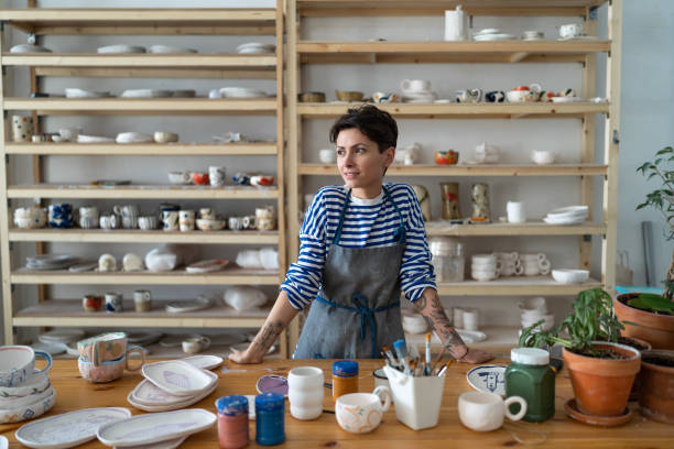 istock Self-employed successful female pottery artist in workshop, creating unique ceramic items in studio 1916715261