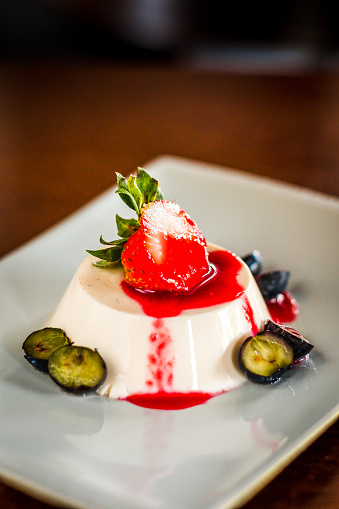 Earl Grey Panna Cotta served with strawberry, blueberries and strawbery sauce