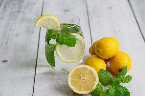 Lemonade with fresh lemon and mint. wooden on a white background. A healthy lifestyle