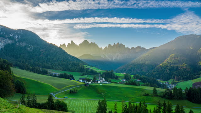 Footage Night to Day Time lapse Scene of Church of St. Magdalena or Santa Maddalena Village over the mountain range in  Dolomites Alps Mountian, South Tyrol, Val di Funes, Italy