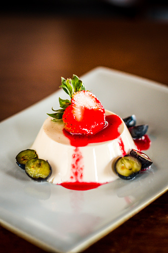 Earl Grey Panna Cotta served with strawberry, blueberries and strawbery sauce