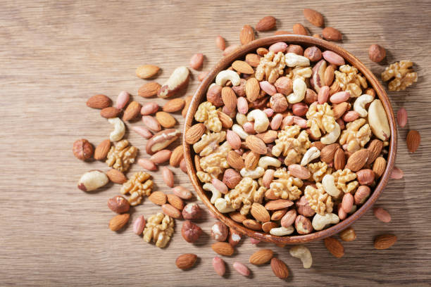 istock bowl of mixed nuts on wooden background, top view 1916749580