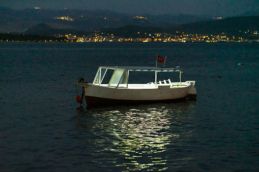 View of an illuminated fisherboat at night.