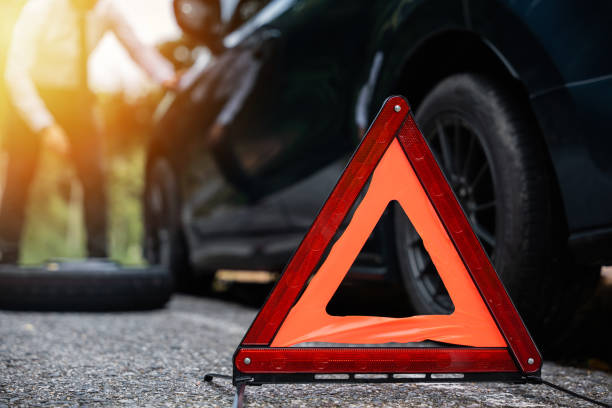 istock Close of red warning triangle and man blur background. 1916759555