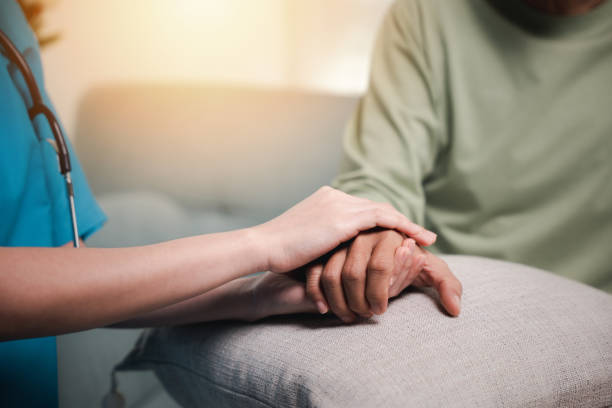 istock Caring nurse helping elderly old man care facility gets help 1916760098