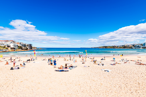 Sydney, Australia - April 20, 2022: Iconic Bondi Beach with people on a day. Bondi Beach is a symbol of Australian beach culture and lifestyle and one of the first public beaches in Australia