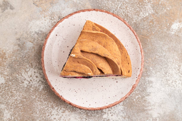 istock Marshmallow cake with cup of coffee on brown concrete. top view 1916788953