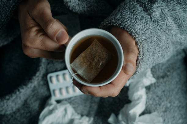 istock ill man warming up with a herbal tea at home 1916792670